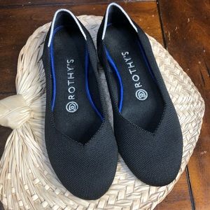 Rothy’s black flats with white halo round toe